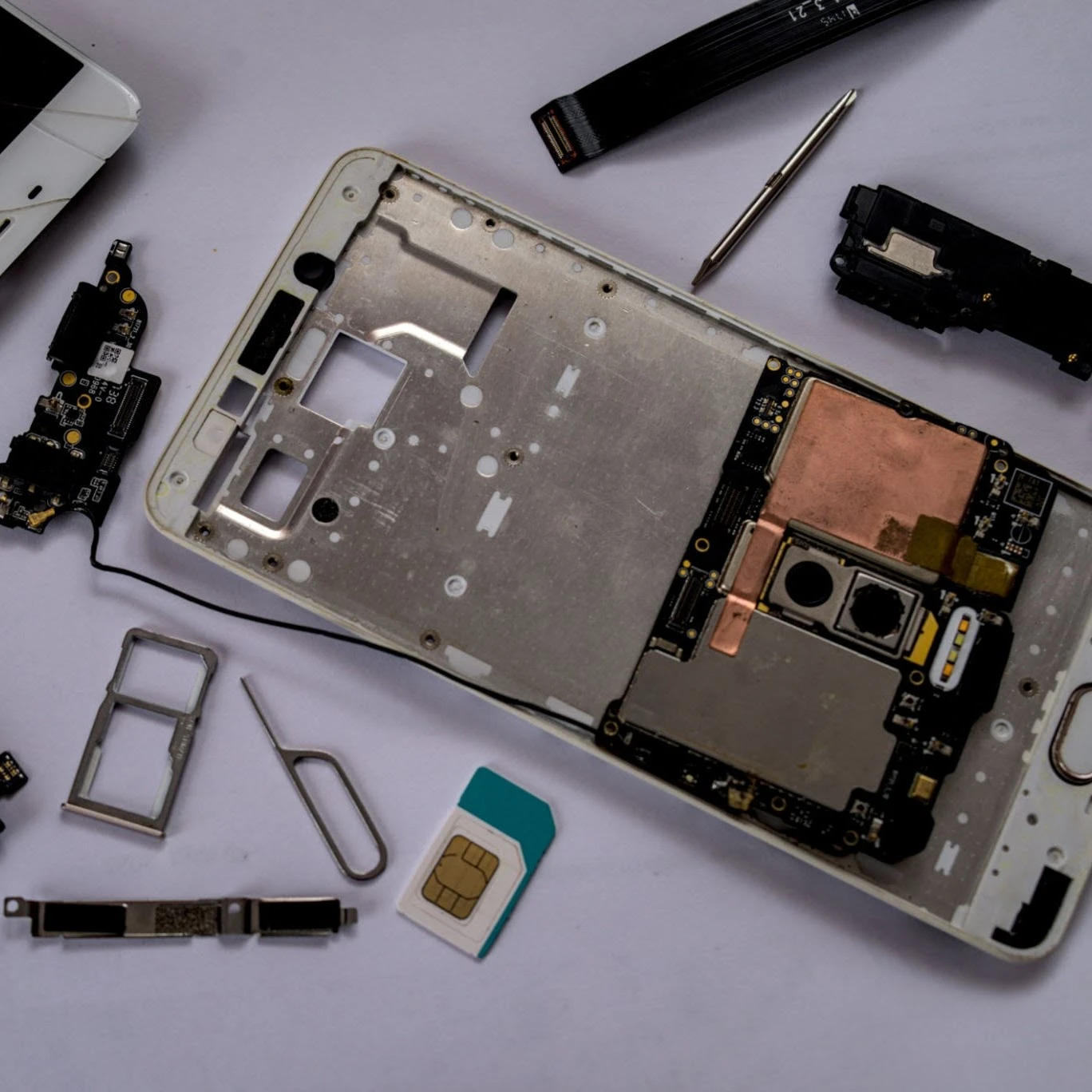 Smartphone-onderdelen en gereedschap op een werktafel